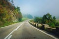 Beautiful road through mountains, leading to misty horizon