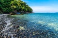 Beautiful rock beach with tourist long tail boat in Koh Hin Ngam, Tarutao National park, Thailand