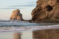 Beautiful rock cliff deux jumeaux in sunset sky on sandy beach of hendaye, basque country, france Royalty Free Stock Photo