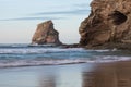 Beautiful rock cliff deux jumeaux in sunset sky on sandy beach of hendaye, basque country, france Royalty Free Stock Photo