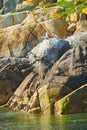 Beautiful rock face. Relief and texture of stone with patterns and moss. Stone natural background. Stone with Moss. Royalty Free Stock Photo