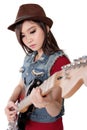 Beautiful rocker girl playing her electric guitar, on white back Royalty Free Stock Photo