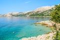 Beautiful rocky beach with crystal clear sea and people snorkeli