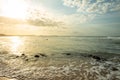 Beautiful rocky beach during sunset. Edge of the sea with white waves