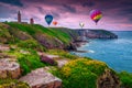 Beautiful rocky and flowery coastline with lighthouse, Cap Frehel, France