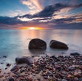 Beautiful rocky sea shore at sunrise or sunset. Royalty Free Stock Photo