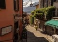 Beautiful rocky sunny alley with historic buildings in Bellagio near Lake Como