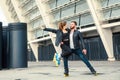 Beautiful roller skater couple with hipster style skating after the rain. Royalty Free Stock Photo