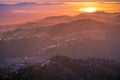 Beautiful rolling hills bathed in the sunset light; the setting sun reflected in the water of the San Francisco Bay in the