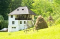 Romanian traditional villa with haystack and green grass - Oltenia province, Romania