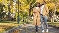 Beautiful romantic black couple walking in city park and enjoying nature Royalty Free Stock Photo