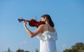 Beautiful asia girl white dress playing on a violin Royalty Free Stock Photo