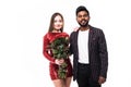 Beautiful romantic asian couple, attractive young asian woman in dress holding red roses and handsome indian man in suit are in Royalty Free Stock Photo