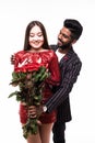 Beautiful romantic asian couple, attractive young woman in dress holding red roses and handsome man in suit are in love isolated Royalty Free Stock Photo