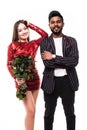 Beautiful romantic asian couple, attractive young woman in dress holding red roses and handsome man in suit are in love isolated Royalty Free Stock Photo