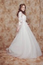 Beautiful and romantic bride in wedding dress with long sleeves. Young redheaded woman in wedding dress Royalty Free Stock Photo