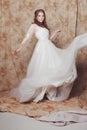 Beautiful and romantic bride in wedding dress with long sleeves. Young redheaded woman in wedding dress Royalty Free Stock Photo