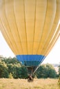 Beautiful romantic Caucasian couple in love hugging in the basket of colorful hot air balloon during summer sunset Royalty Free Stock Photo