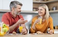 Beautiful romantic couple having breakfast at home, talking Royalty Free Stock Photo