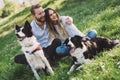 Romantic couple in love walking dogs in nature and smiling Royalty Free Stock Photo