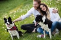 Romantic couple in love walking dogs in nature and smiling Royalty Free Stock Photo