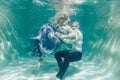 Beautiful romantic couple of lovers hugging gently under water