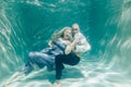 Beautiful romantic couple of lovers hugging gently under water