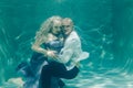 Beautiful romantic couple of lovers hugging gently under water