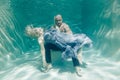 Beautiful romantic couple of lovers hugging gently under water