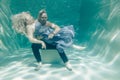 Beautiful romantic couple of lovers hugging gently under water