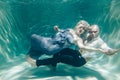 Beautiful romantic couple of lovers hugging gently under water