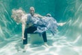 Beautiful romantic couple of lovers hugging gently under water