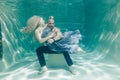 Beautiful romantic couple of lovers hugging gently under water
