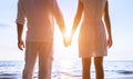 Beautiful romantic couple in white clothes holding hands at beach Royalty Free Stock Photo