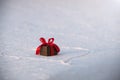 Beautiful romantic gift box on a white snow. Royalty Free Stock Photo