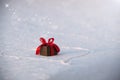 Beautiful romantic gift box on a white snow. Royalty Free Stock Photo