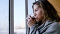 Beautiful romantic girl with a cup of tea near the winter window. Winter day, cozy mood. Royalty Free Stock Photo