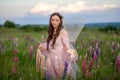 Beautiful romantic girl on nature field of flowers. Photo of sensual woman.