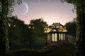 Beautiful illuminated pavilion at night in lush park Royalty Free Stock Photo