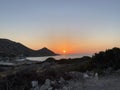 Beautiful romantic sunset on the Aegean Sea with a lighthouse. Royalty Free Stock Photo