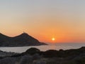 Beautiful romantic sunset on the Aegean Sea with a lighthouse. Royalty Free Stock Photo