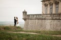 Beautiful romantic wedding couple of newlyweds hugging near old castle