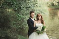 Beautiful romantic wedding couple of newlyweds hugging in park on sunset Royalty Free Stock Photo