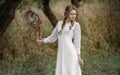 Beautiful romantic woman with an owl. The bird sits on her hand. Royalty Free Stock Photo