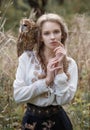 Beautiful romantic woman with an owl. The bird sits on her shoulder.