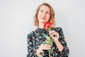 Beautiful romantic young blonde woman in dress with red rose on white background isolated Royalty Free Stock Photo