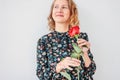 Beautiful romantic young blonde woman in dress with red rose on white background isolated Royalty Free Stock Photo