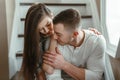 Beautiful romantic young couple man woman in love hugging, kissing, indoors Royalty Free Stock Photo