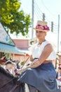 Beautiful romantic young woman riding horse