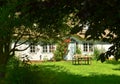 Beautiful and romantical entrance and garden of an old german farmhouse with framework and blooming plants Royalty Free Stock Photo